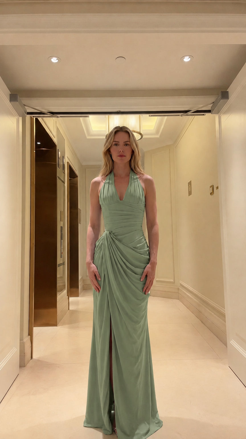 Front view of woman wearing sage green halter neck evening gown with draped waist
