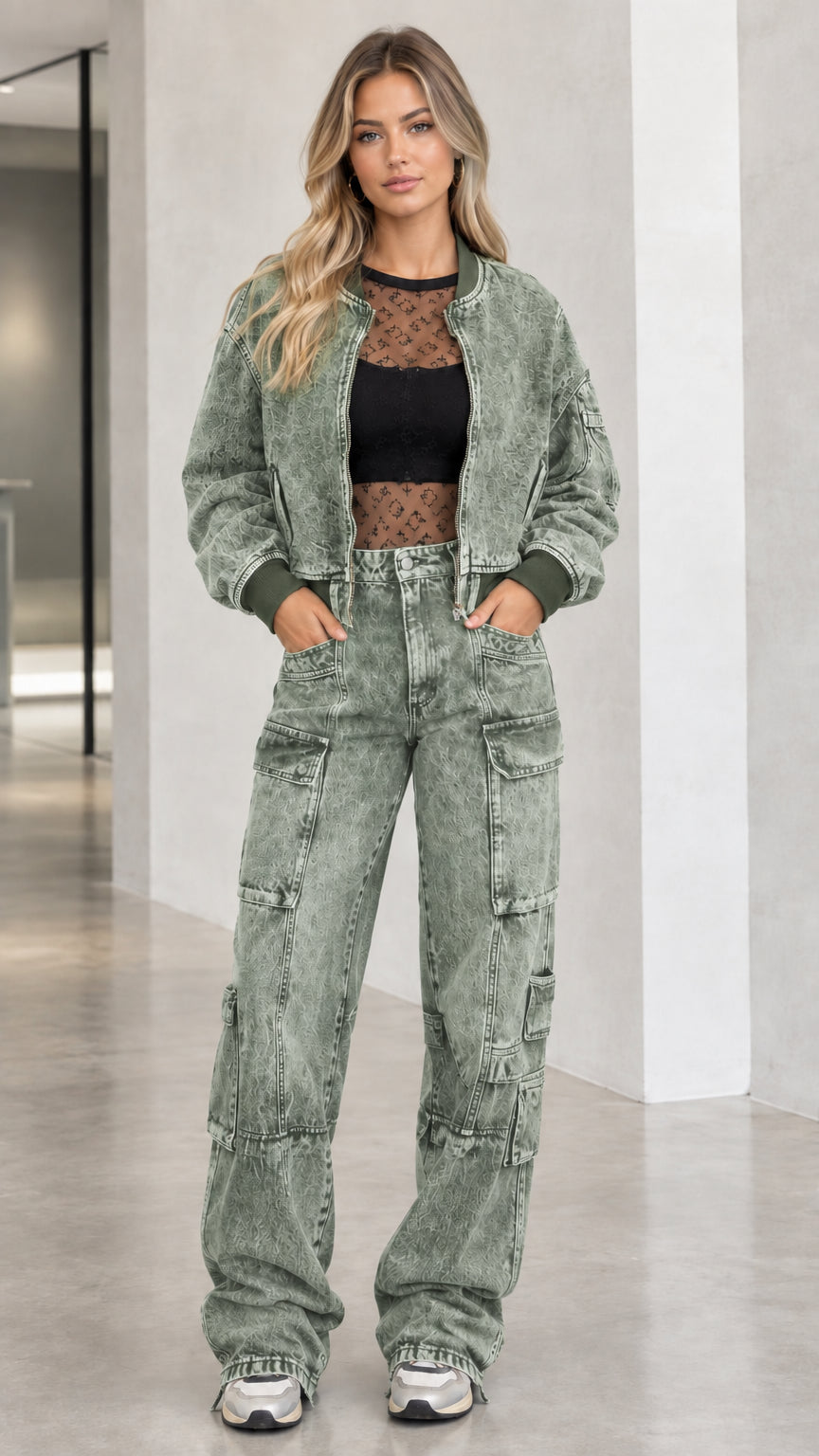 Full body front view of model wearing sage green washed denim bomber jacket and cargo pants set