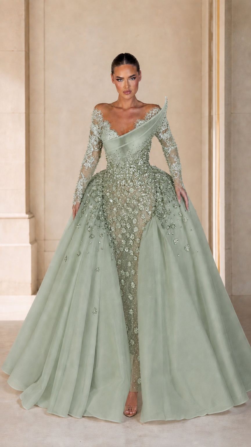 Front view of model wearing sage green asymmetrical lace and sequin ball gown