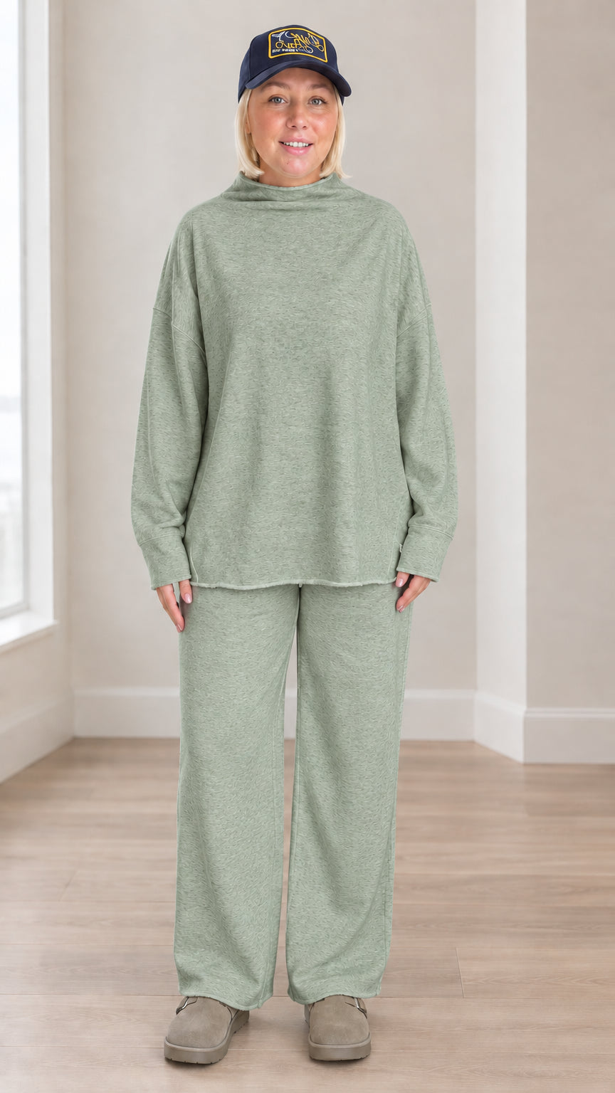 Front view of model wearing sage green mock neck sweatshirt and wide leg lounge set