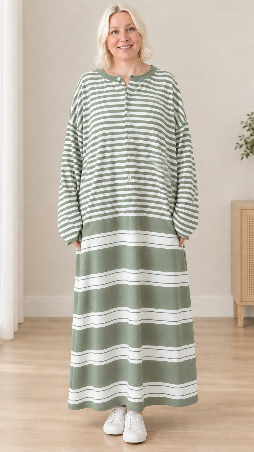 Front view of woman wearing sage green striped long sleeve maxi dress