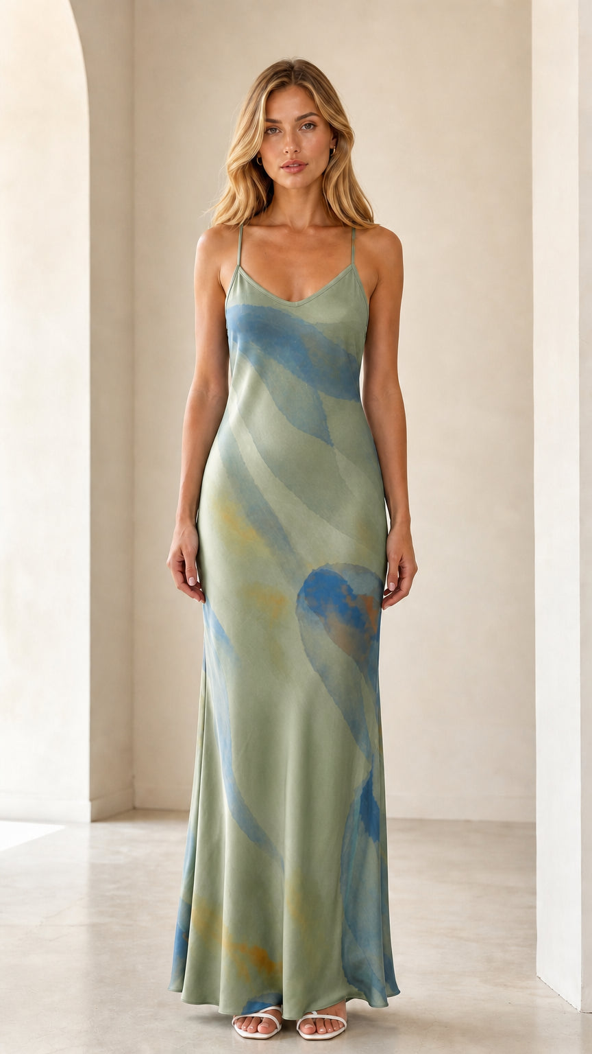 Model wearing sage green fluid watercolor print satin maxi slip dress