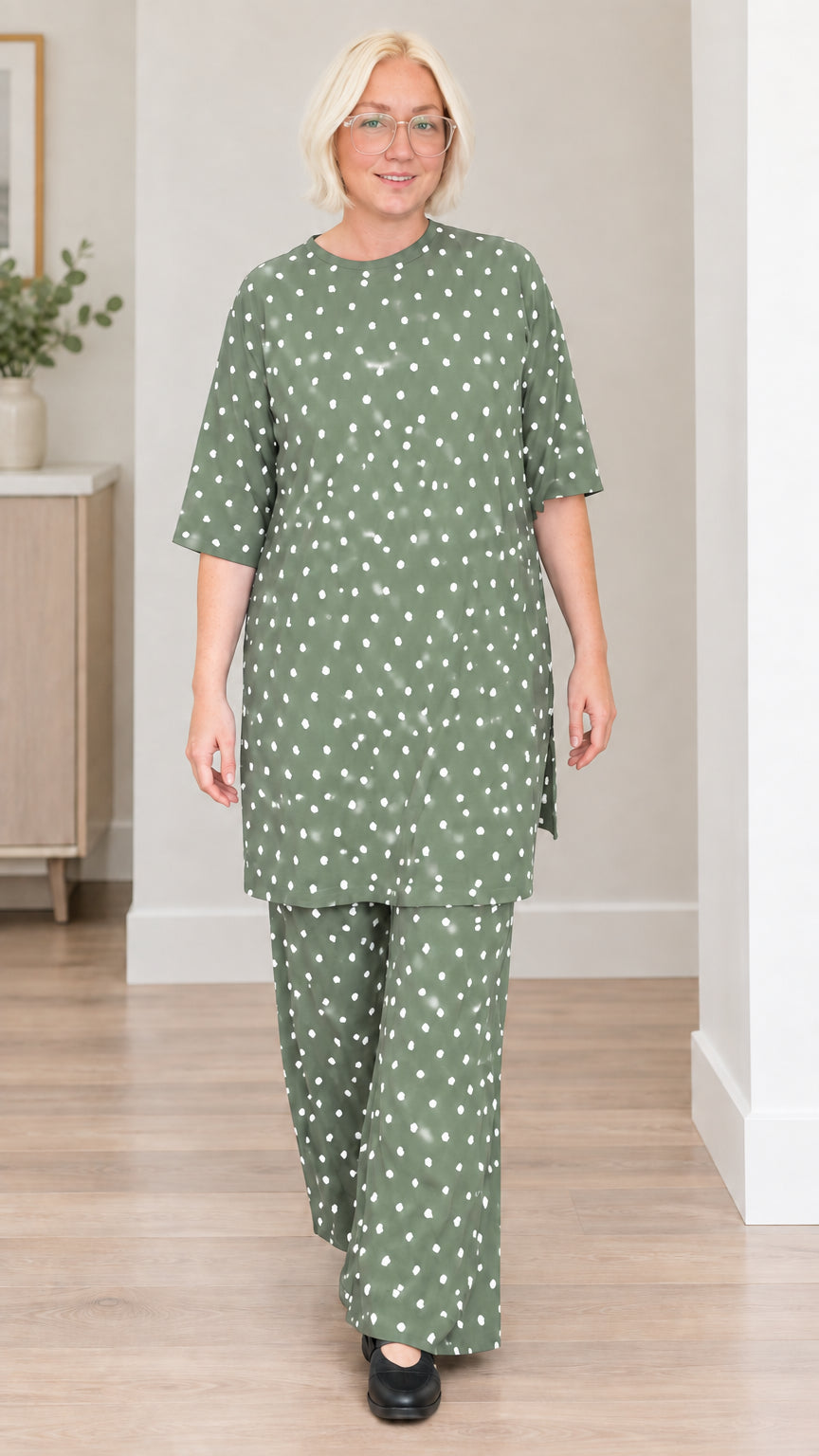 Front view of woman wearing sage green polka dot tunic and pants set
