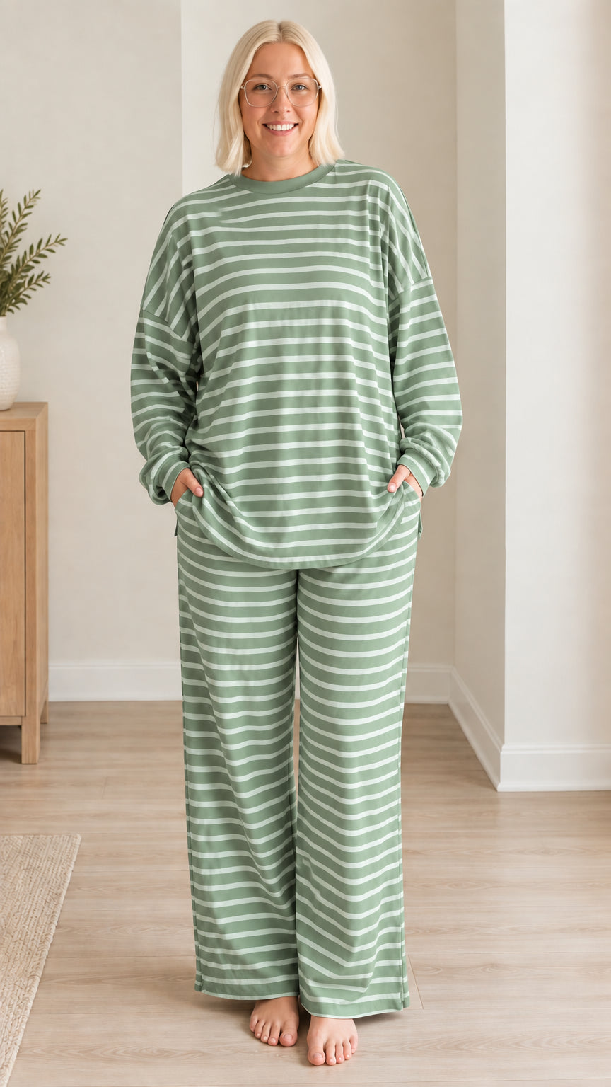 Front view of woman wearing sage green striped long sleeve pajama set