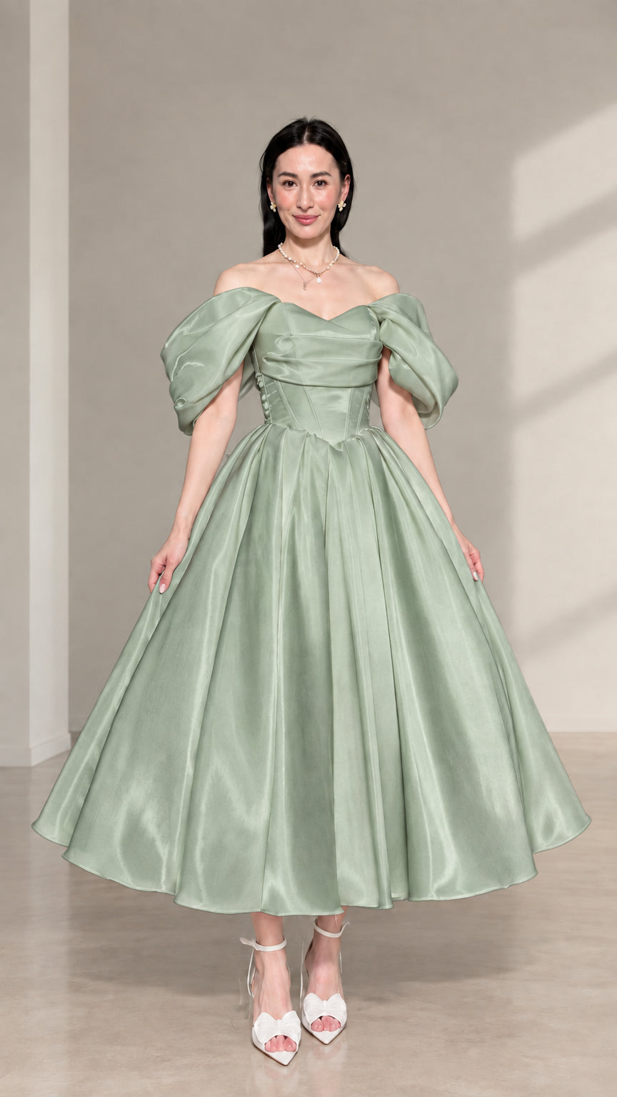Front view of sage green off-the-shoulder corset satin midi dress with puff sleeves