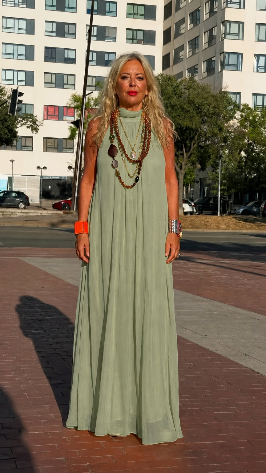 Front full-length view of woman wearing sage green high neck sleeveless chiffon maxi dress