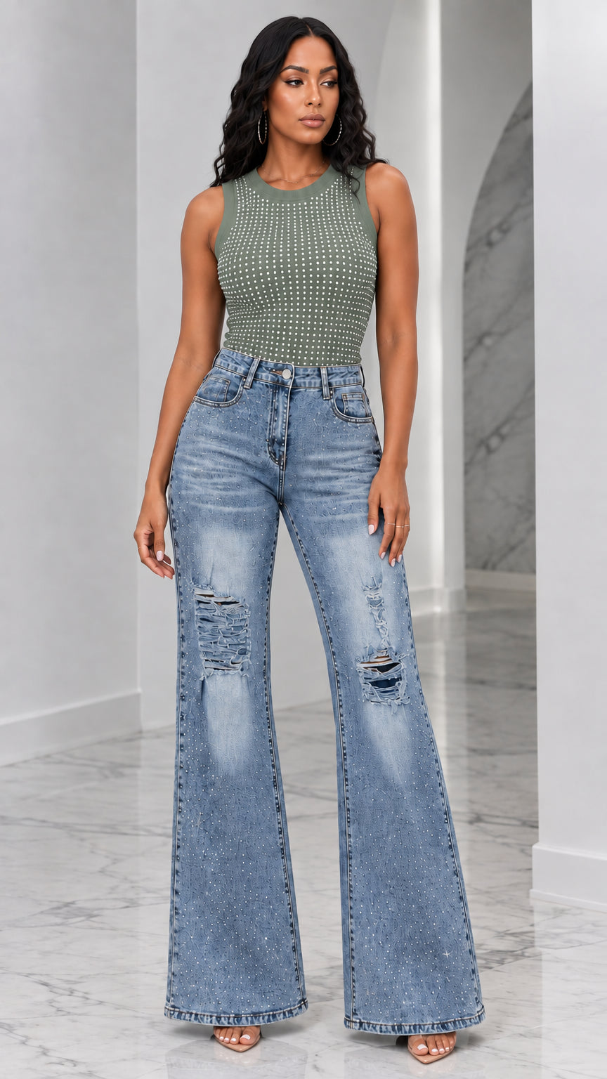 Full-length view of woman wearing olive green rhinestone tank top and distressed flare jeans