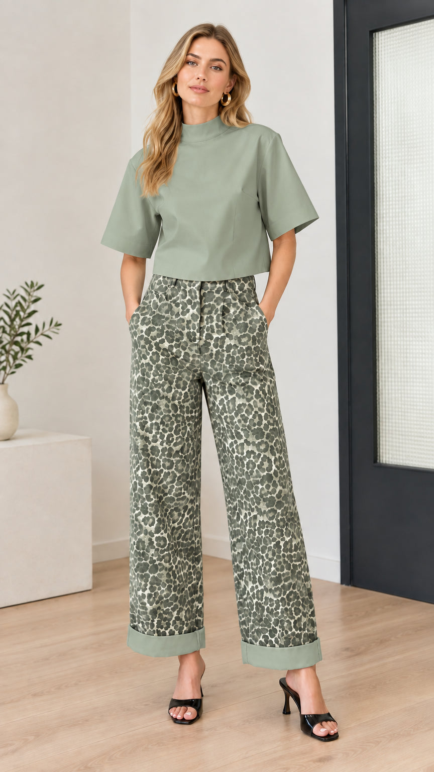 Model wearing sage green mock-neck top and sage green printed wide-leg pants