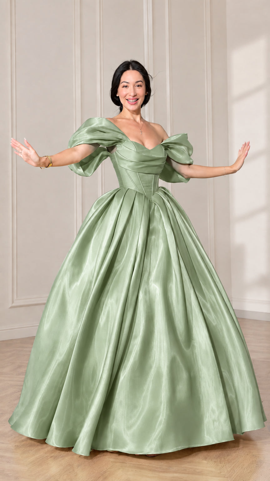 Front view of model wearing a sage green off-shoulder puff sleeve corset ball gown