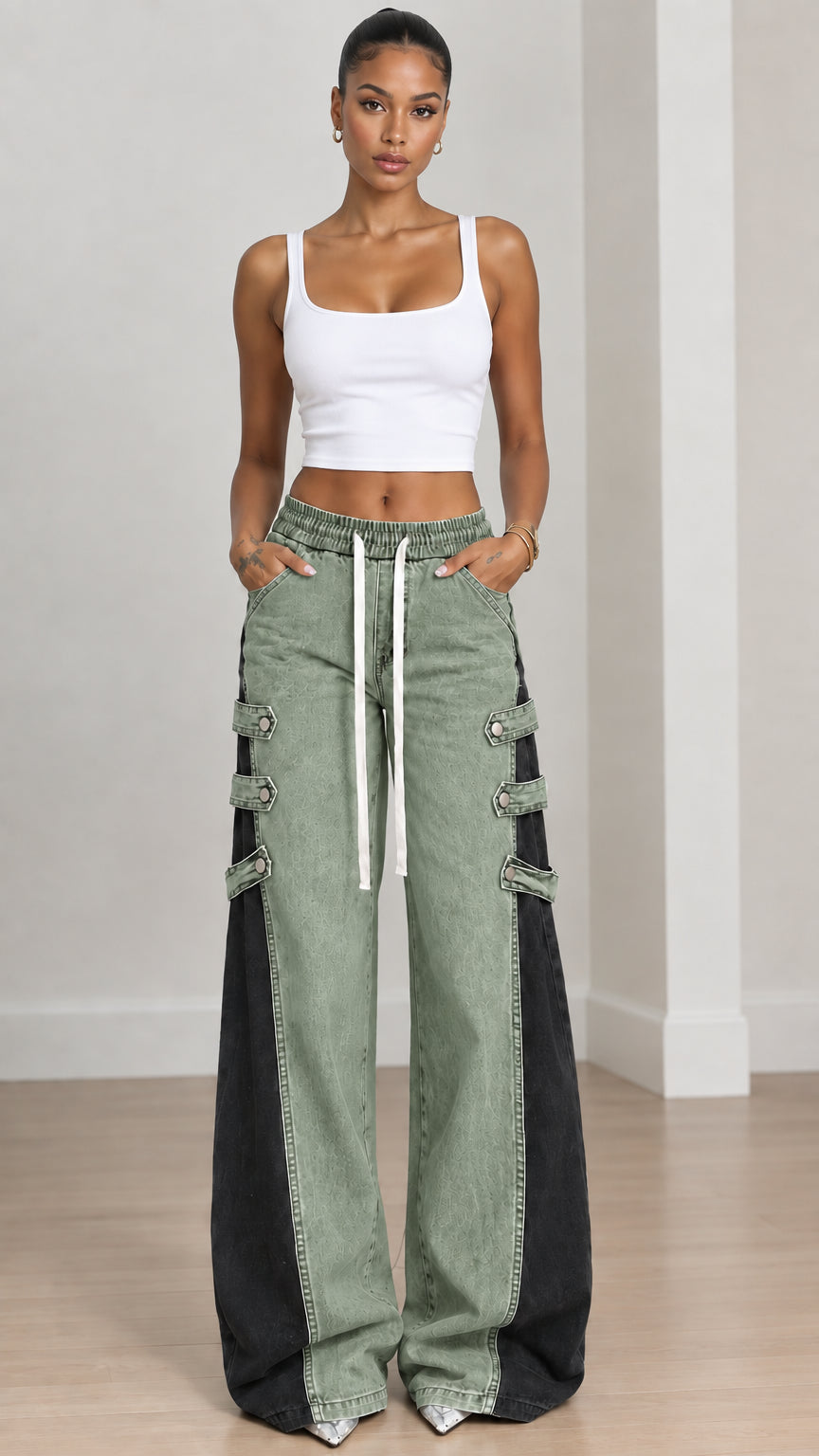 Full front view of sage green and black two-tone wide-leg jeans styled with white tank