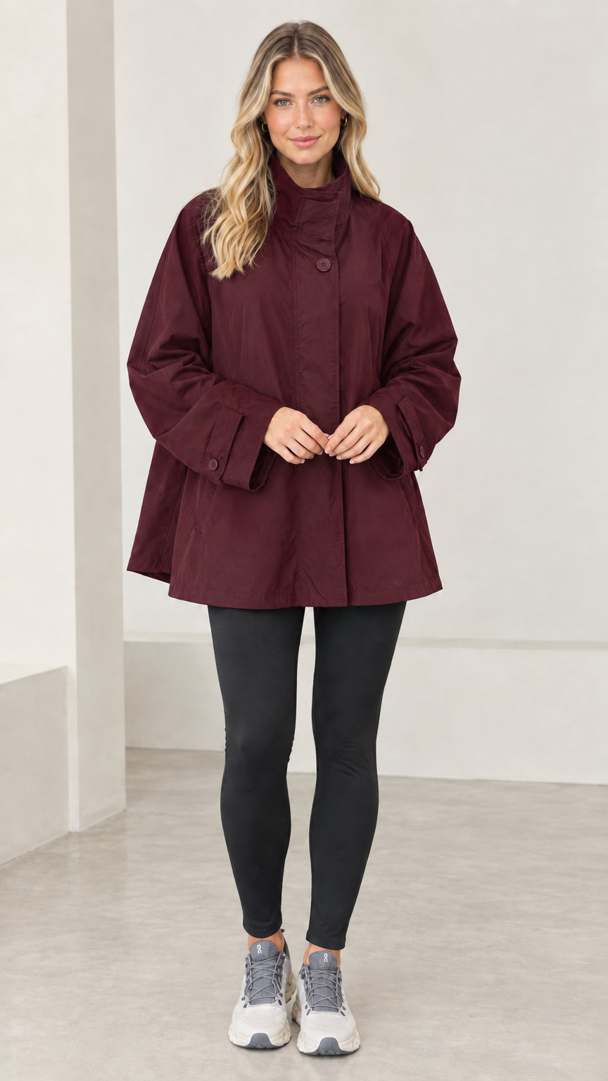 Front view of model wearing burgundy stand collar swing jacket