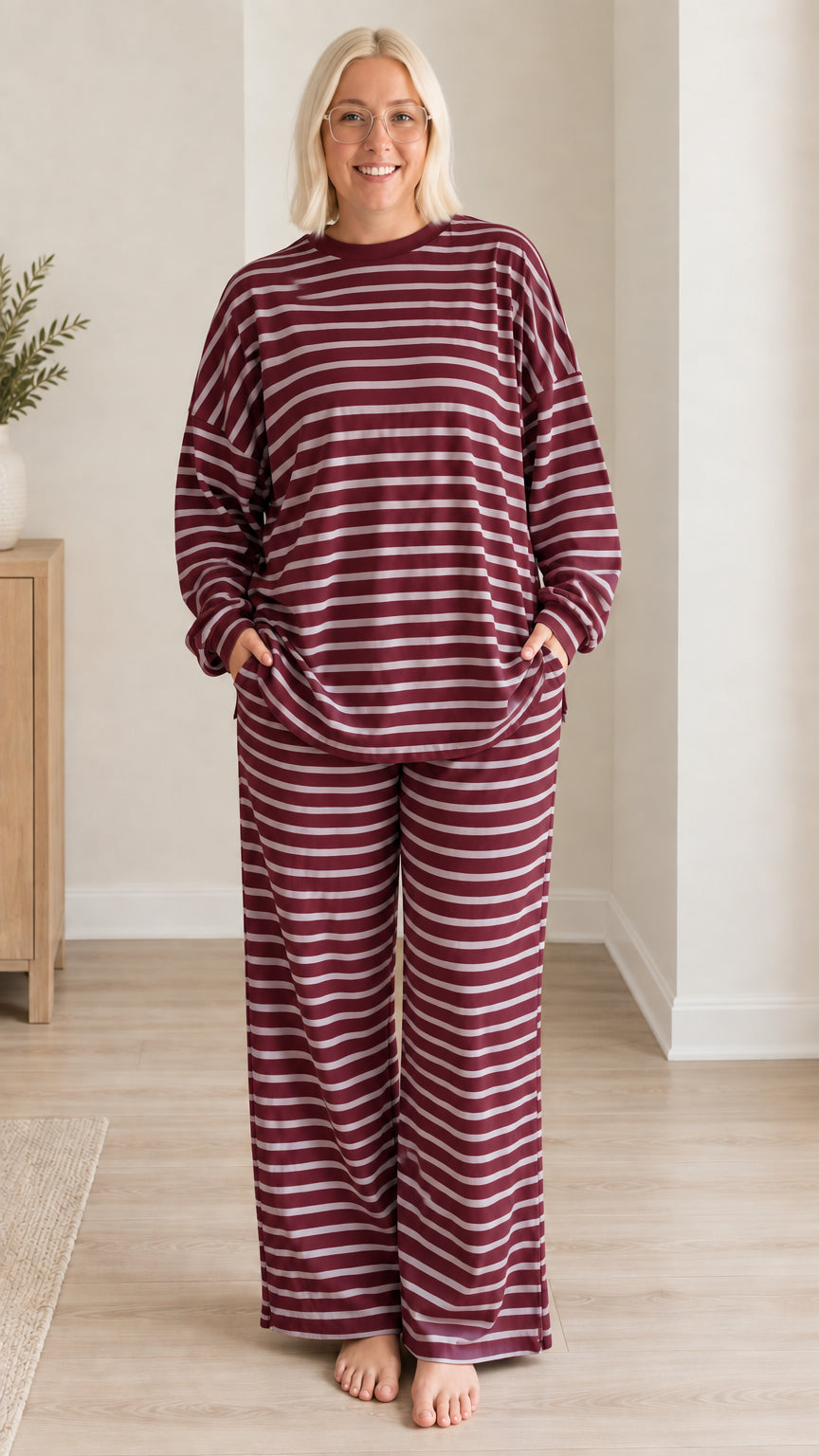 Front view of woman wearing burgundy striped long sleeve top and wide leg pants set