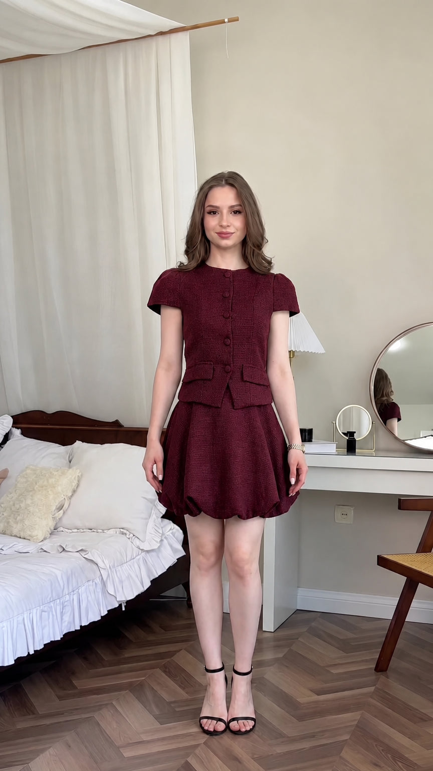 Front view of model wearing burgundy wine red tweed two-piece bubble skirt set