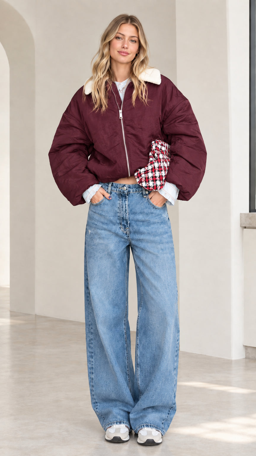 Full-length front view of model wearing burgundy cropped puffer jacket with white fleece collar