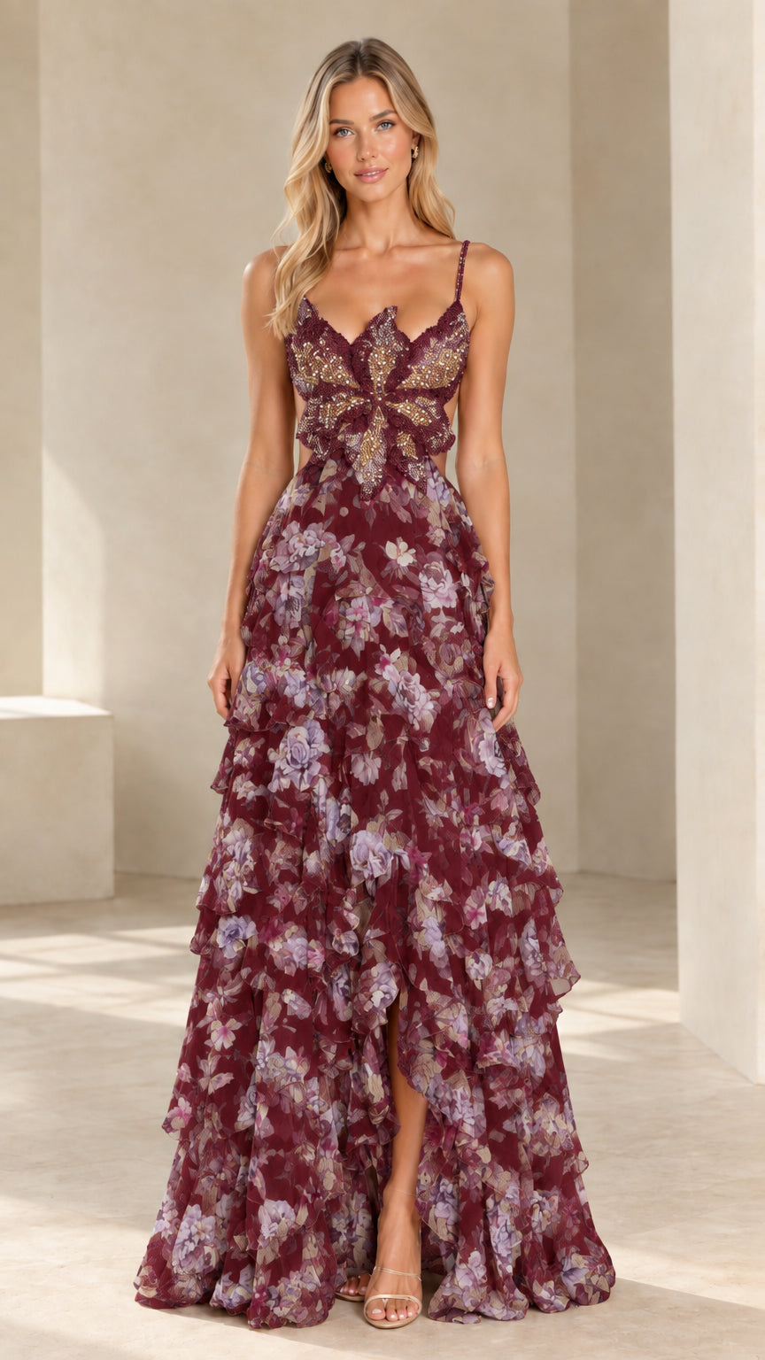 Front view of model wearing burgundy floral beaded butterfly bodice tiered ruffle gown