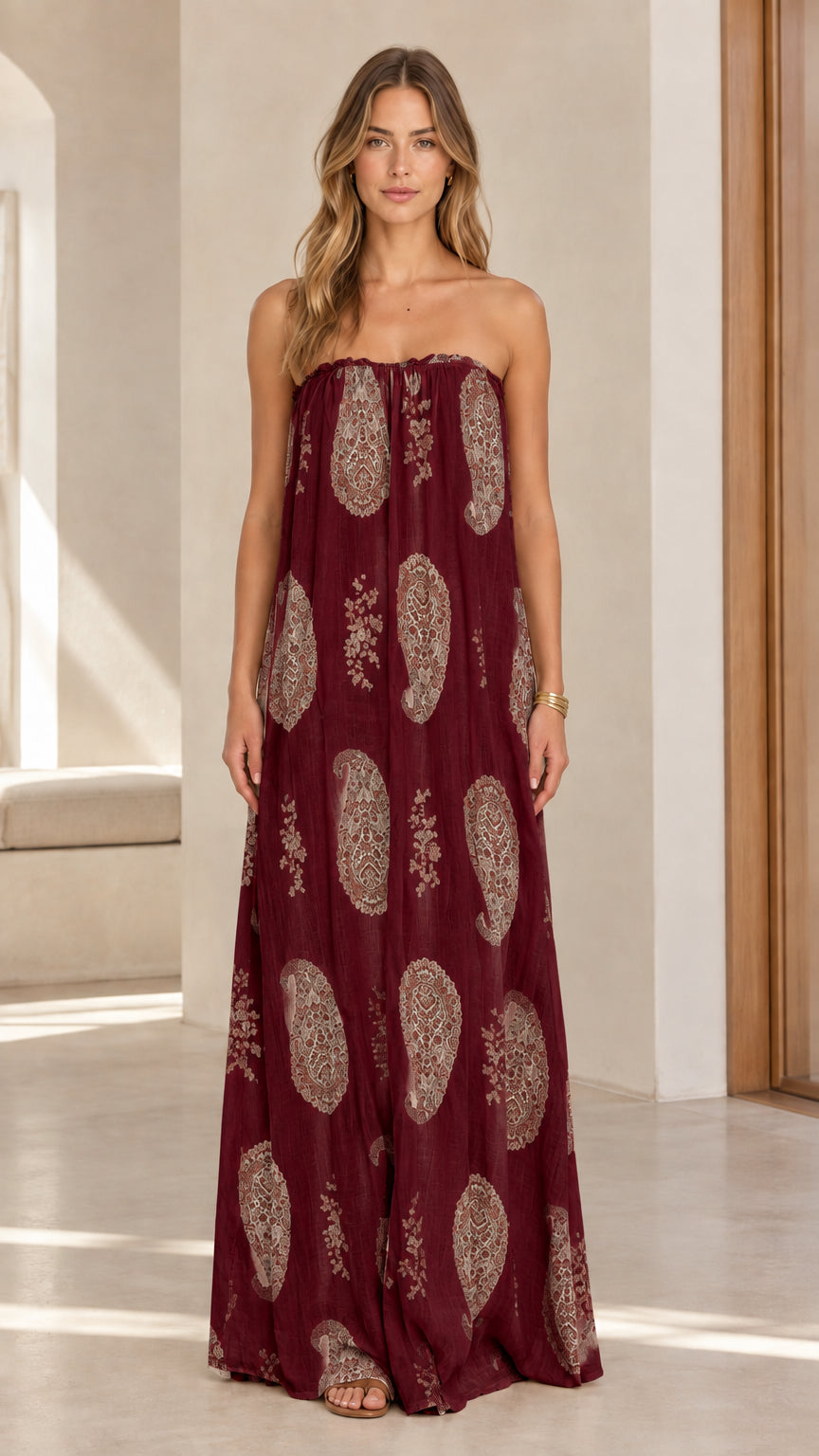 Model wearing burgundy bohemian paisley strapless maxi dress front view