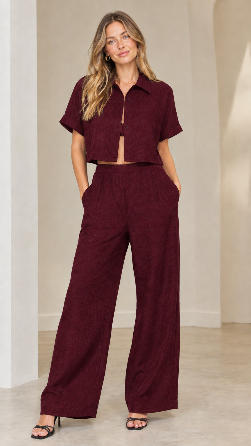 Front view of woman wearing burgundy wine collared cropped top and wide-leg pants matching set
