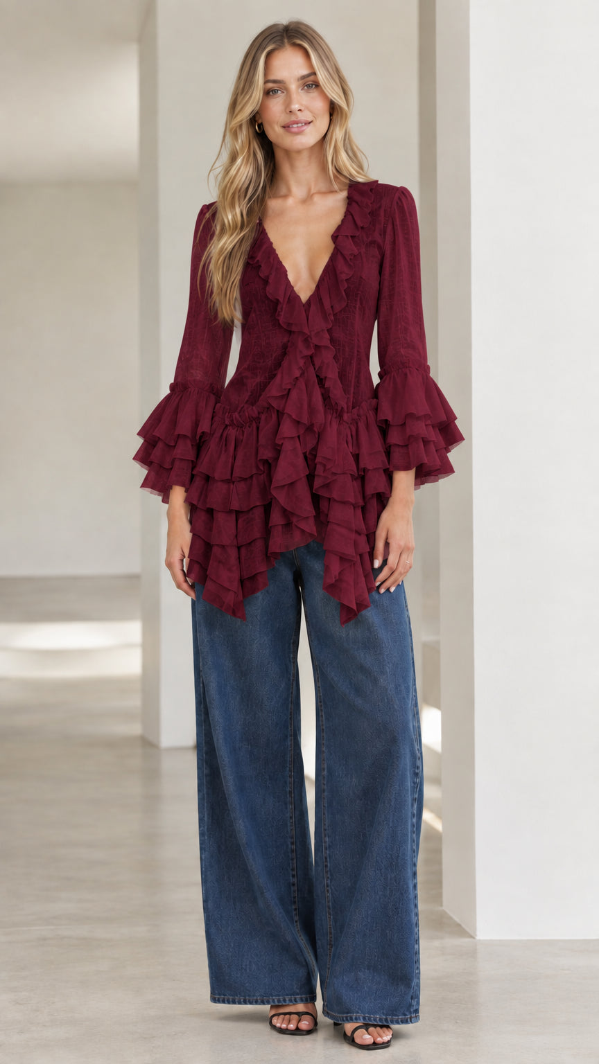 Model wearing burgundy wine tiered ruffle blouse