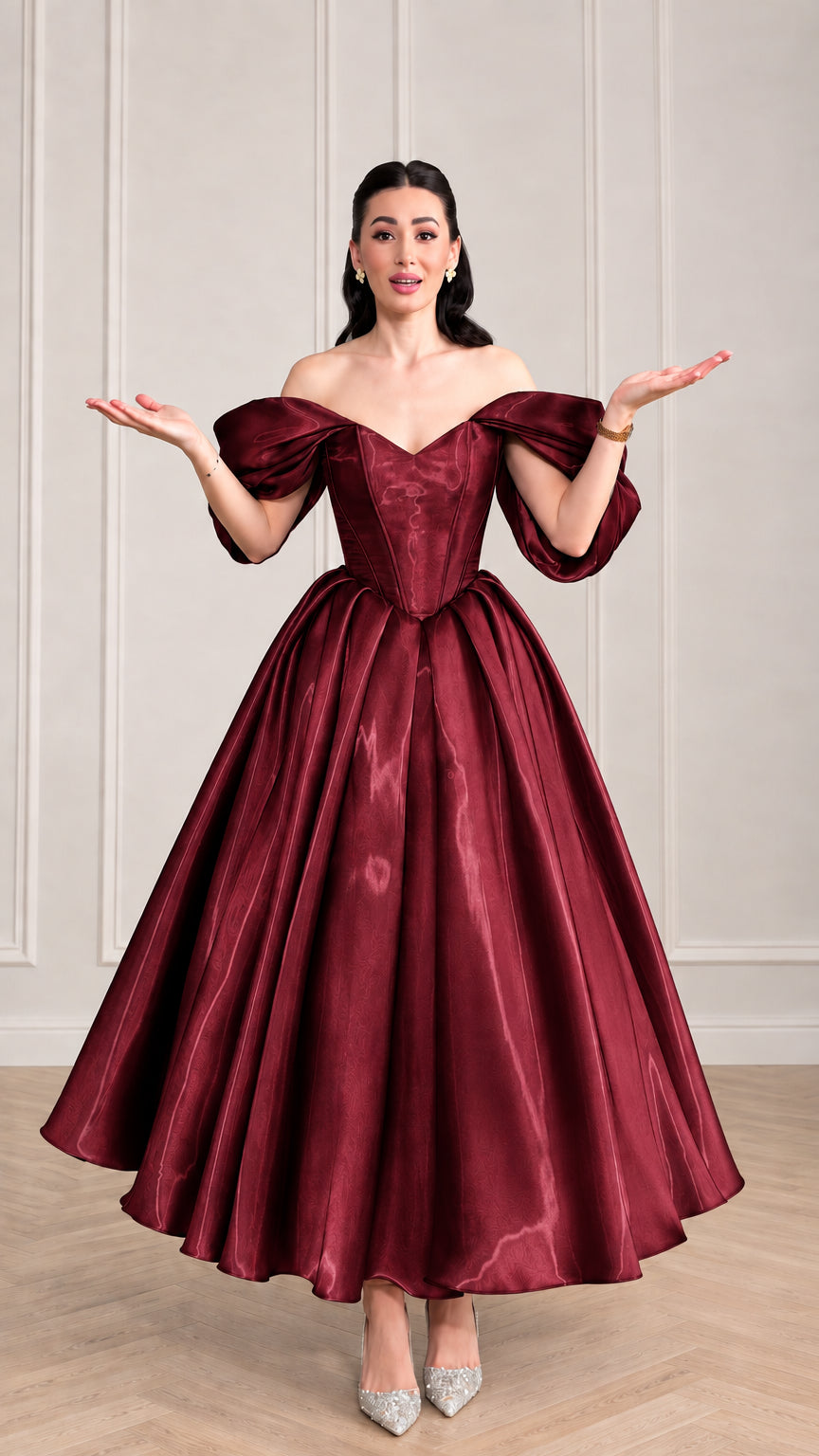 Woman wearing burgundy wine red corset satin ball gown with sweetheart neckline