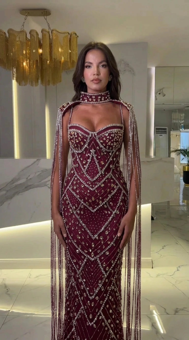 Front view of burgundy wine embellished formal evening gown with beaded fringe cape