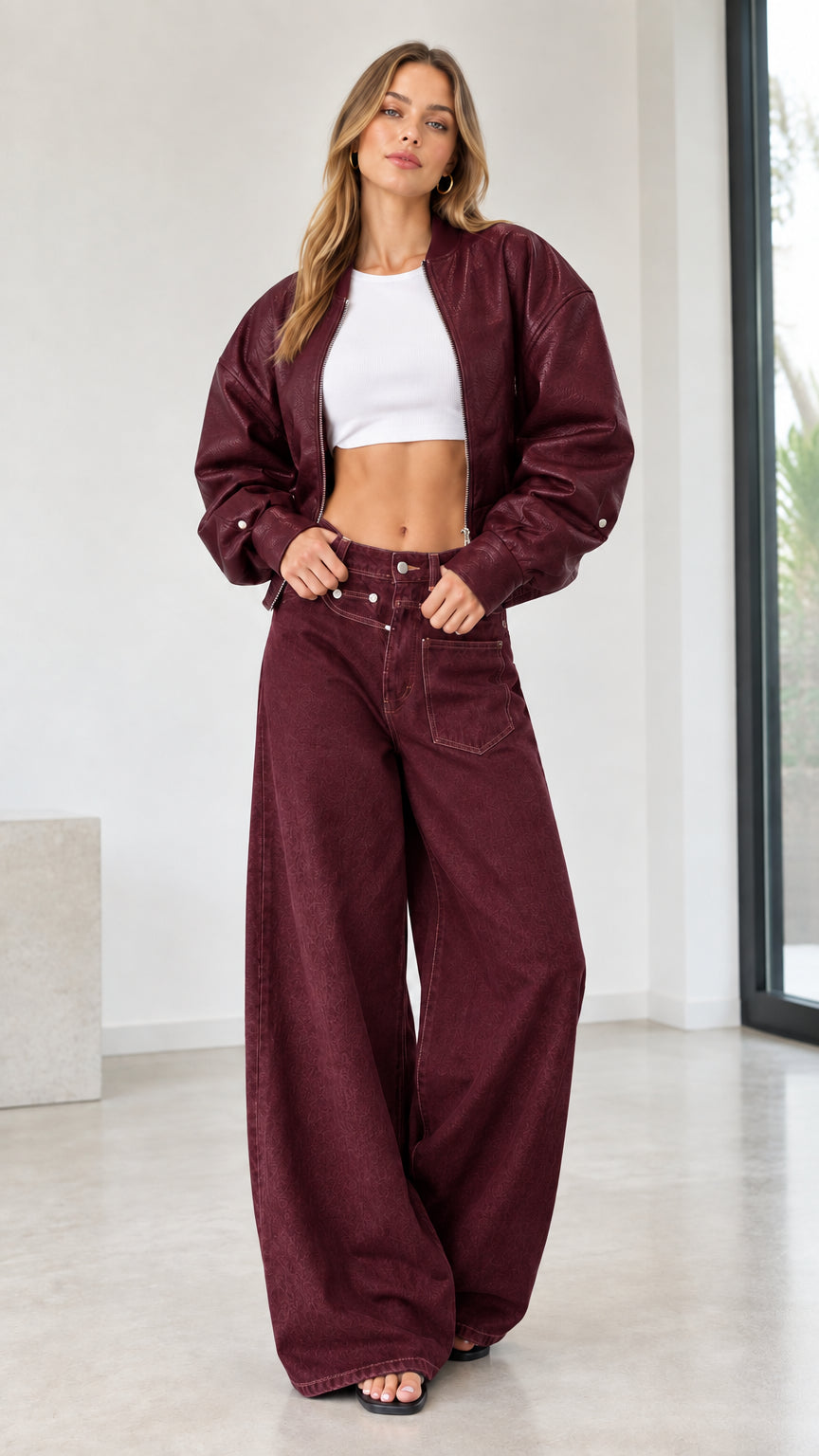 Full front view of model wearing monochrome burgundy bomber jacket and wide leg pants set