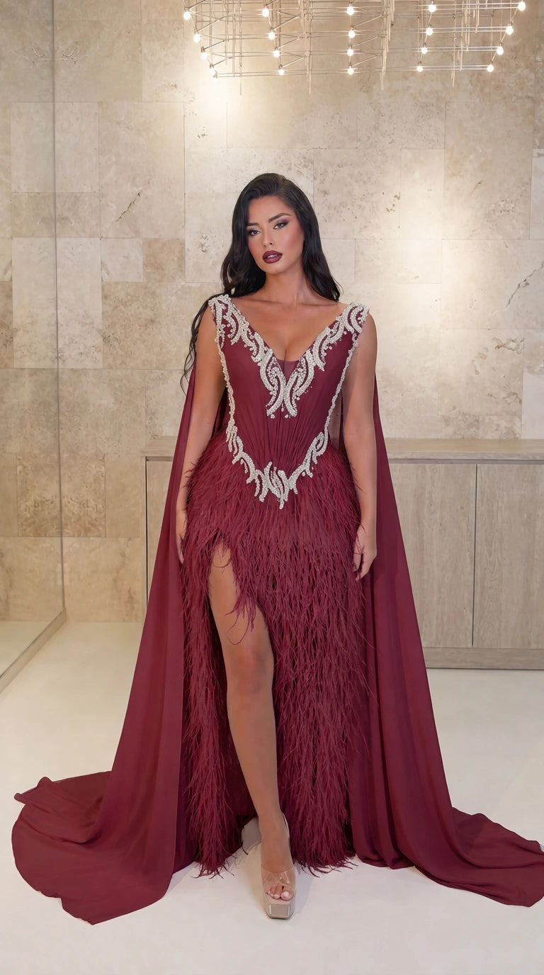 Model wearing Burgundy red embellished V-neck feather cape evening gown