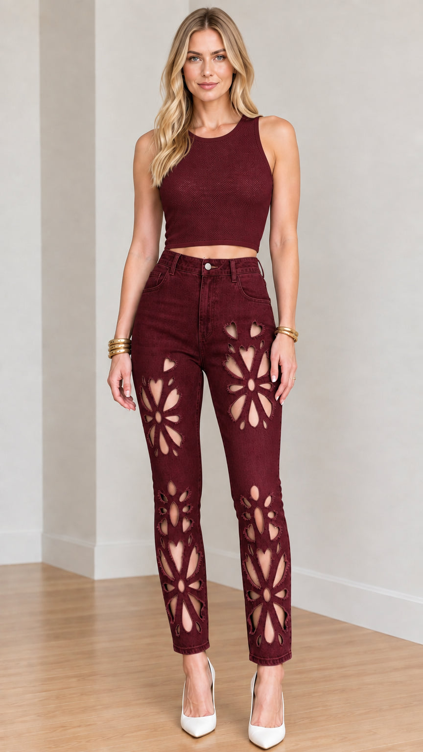 Full-length front view of model wearing burgundy floral cut-out jeans with wine red crop top
