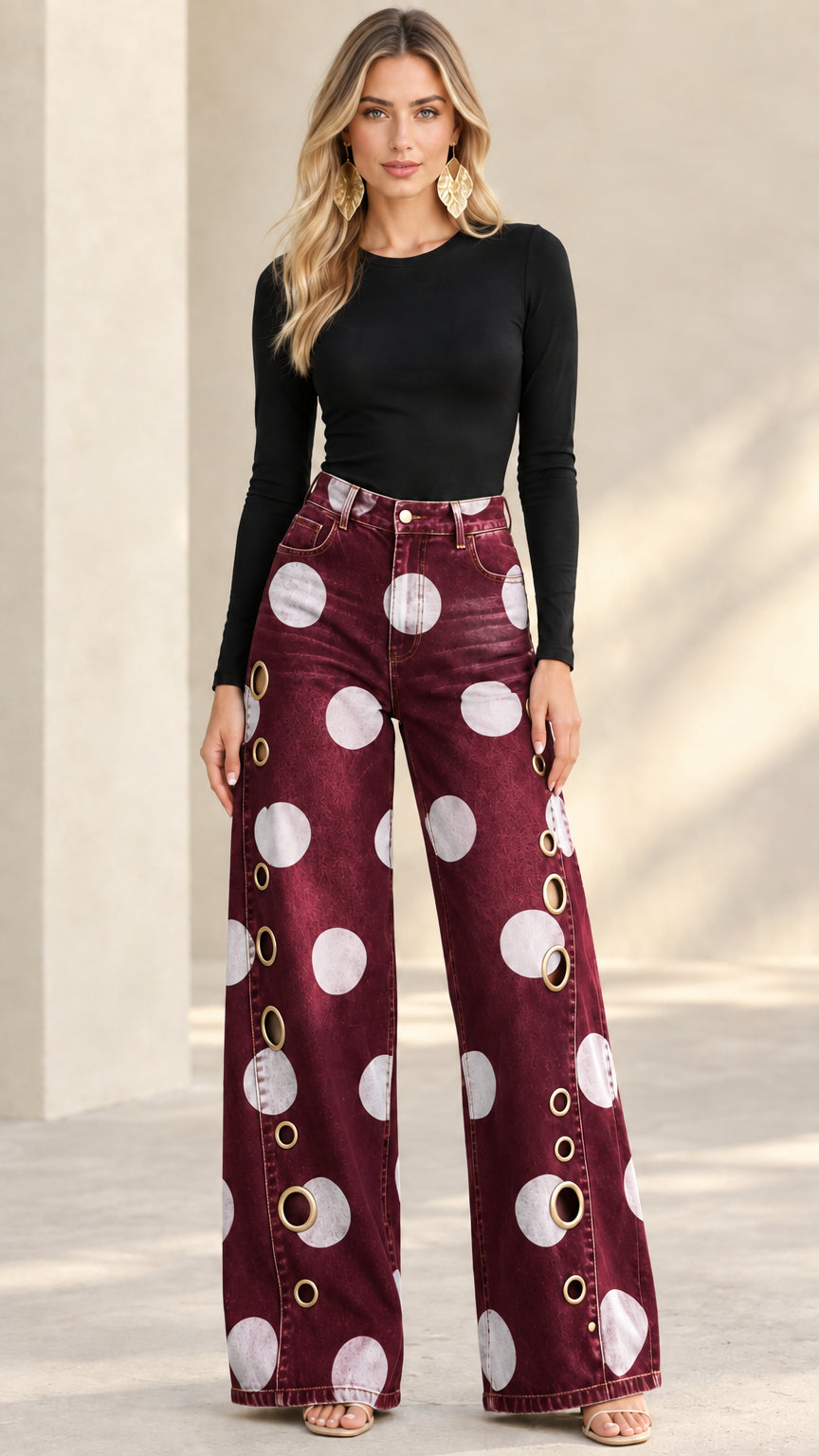 Model wearing burgundy wine polka dot wide leg jeans with side grommets