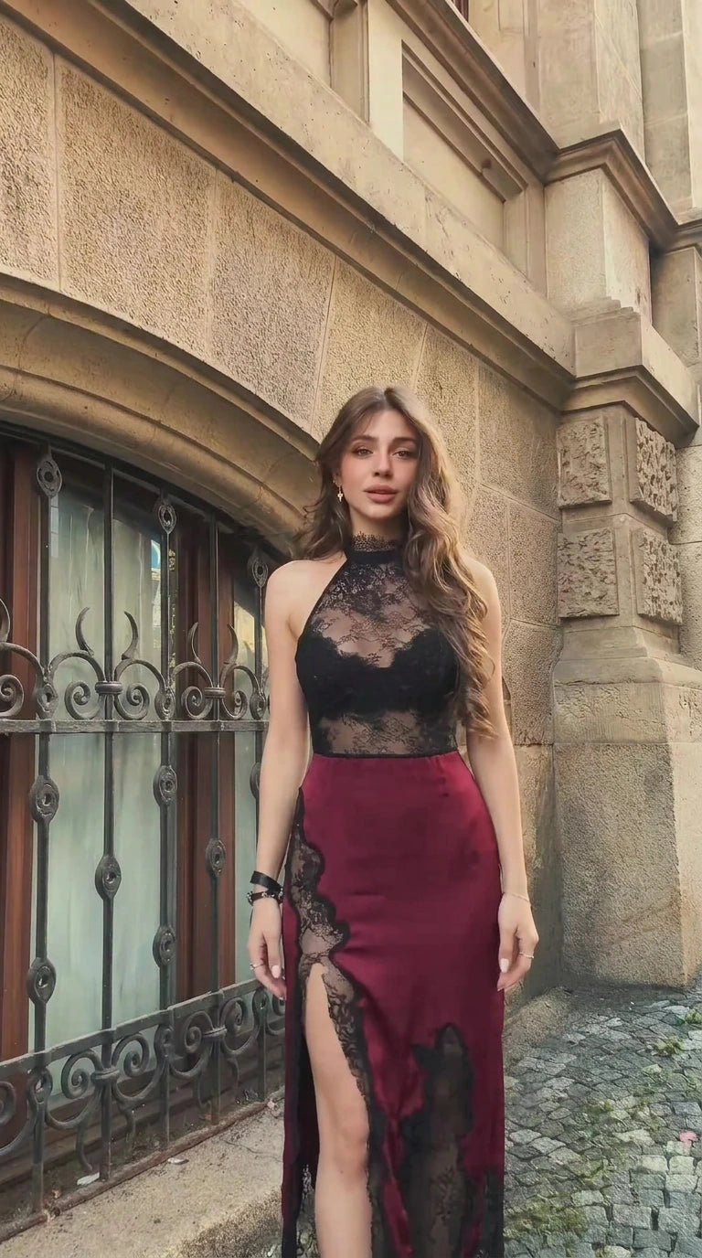 Front view of woman wearing burgundy and black lace halter maxi dress