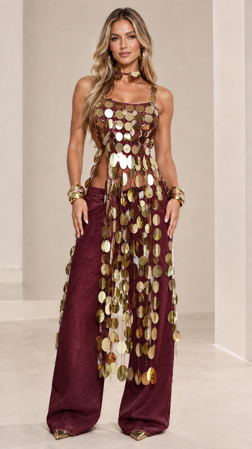 Model wearing gold metallic disc fringe top paired with burgundy shimmer wide-leg pants