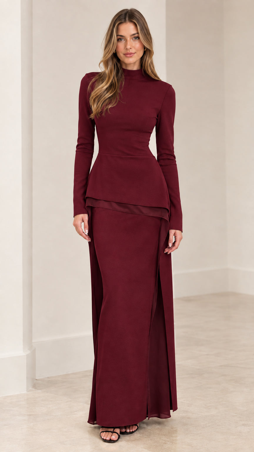 Front view of woman wearing burgundy wine long sleeve mock neck peplum top and maxi skirt set