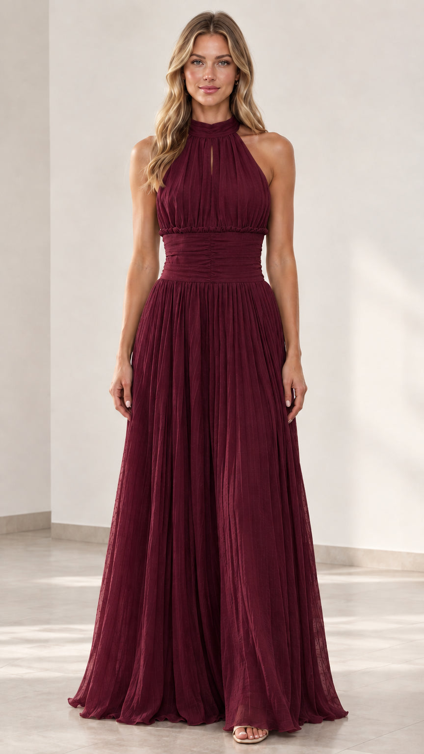 Front view of woman wearing burgundy wine halter pleated maxi dress
