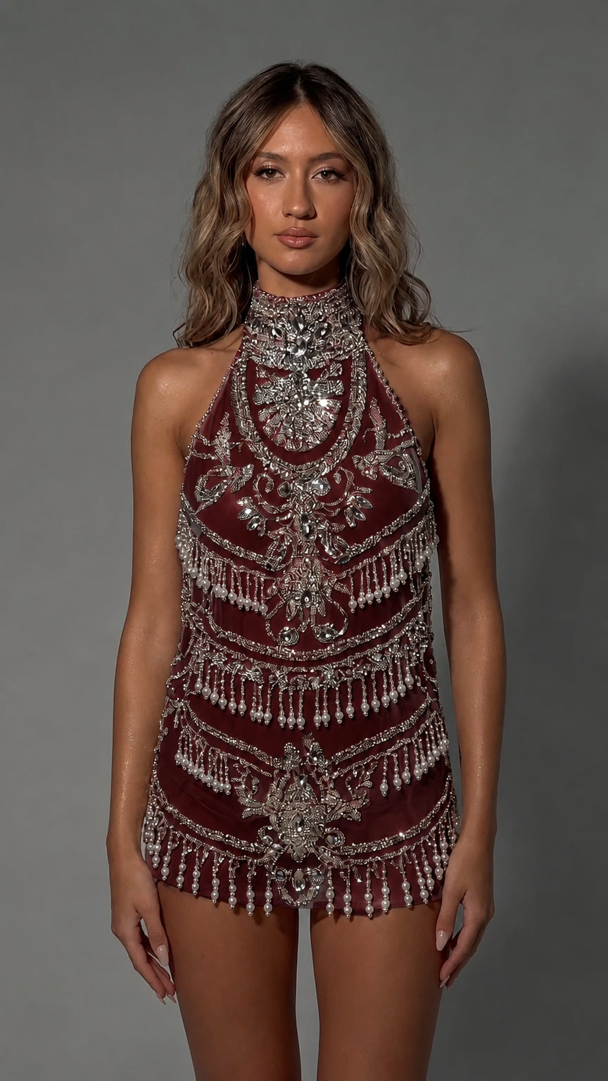 Model wearing Burgundy halter neck beaded fringe mini dress