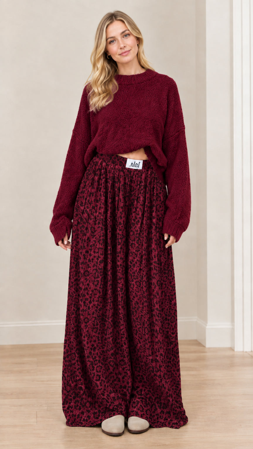 Model wearing burgundy wine knit sweater and coordinating burgundy leopard print wide-leg pants