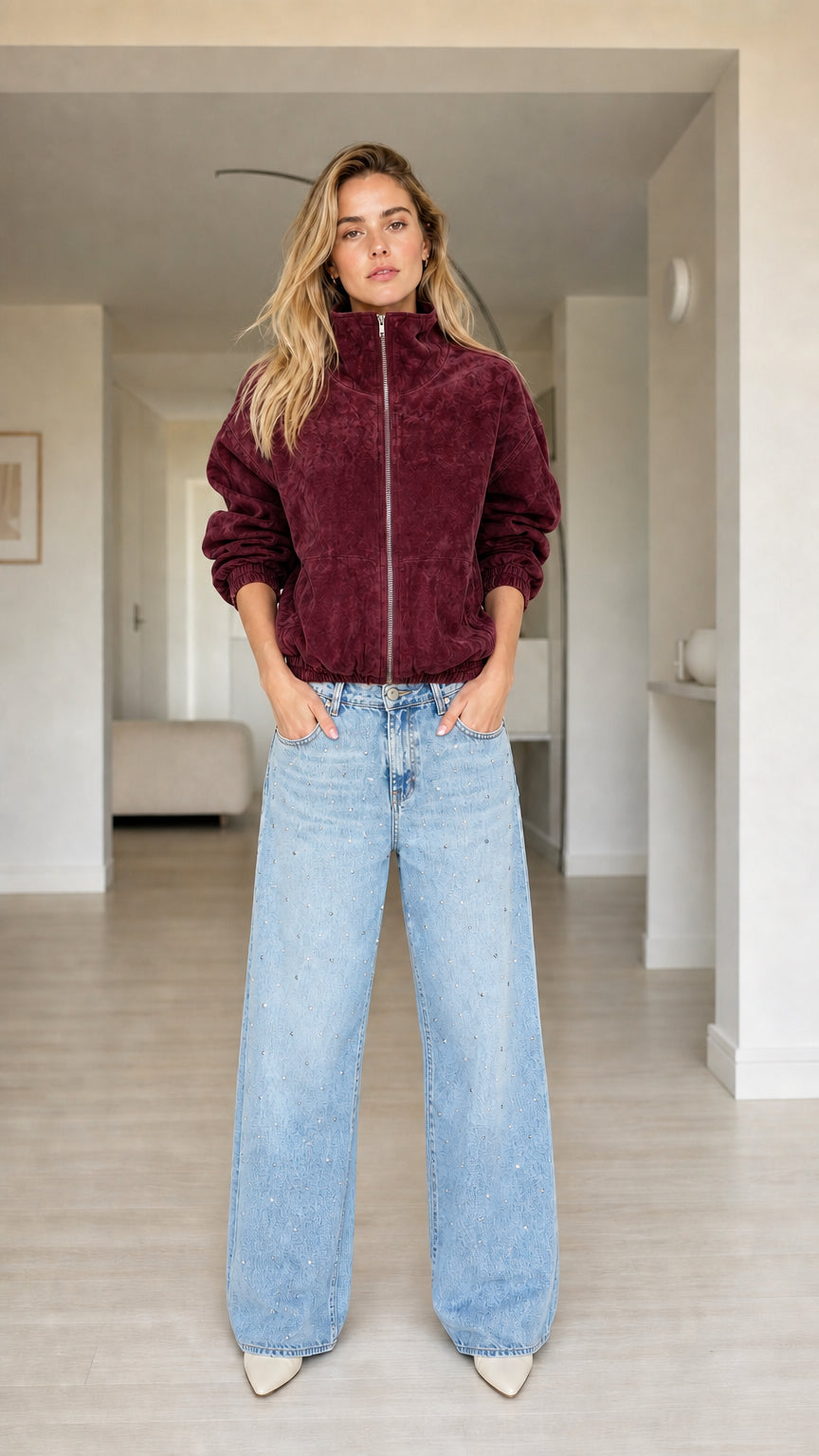 Model wearing burgundy plush zip-up jacket with stand collar