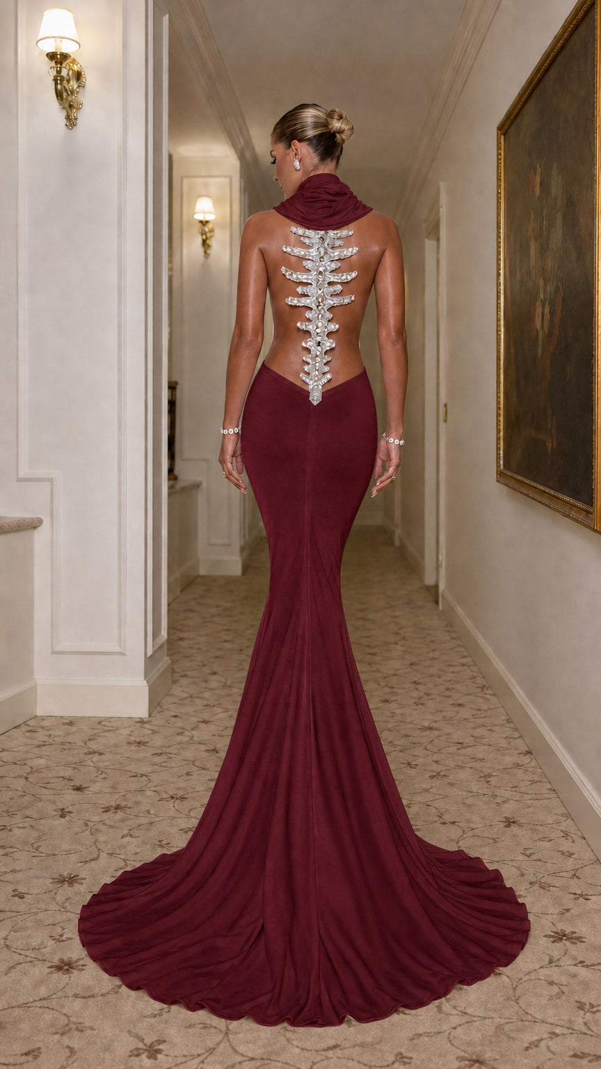 Back view of burgundy wine red open-back mermaid evening dress with crystal spine train