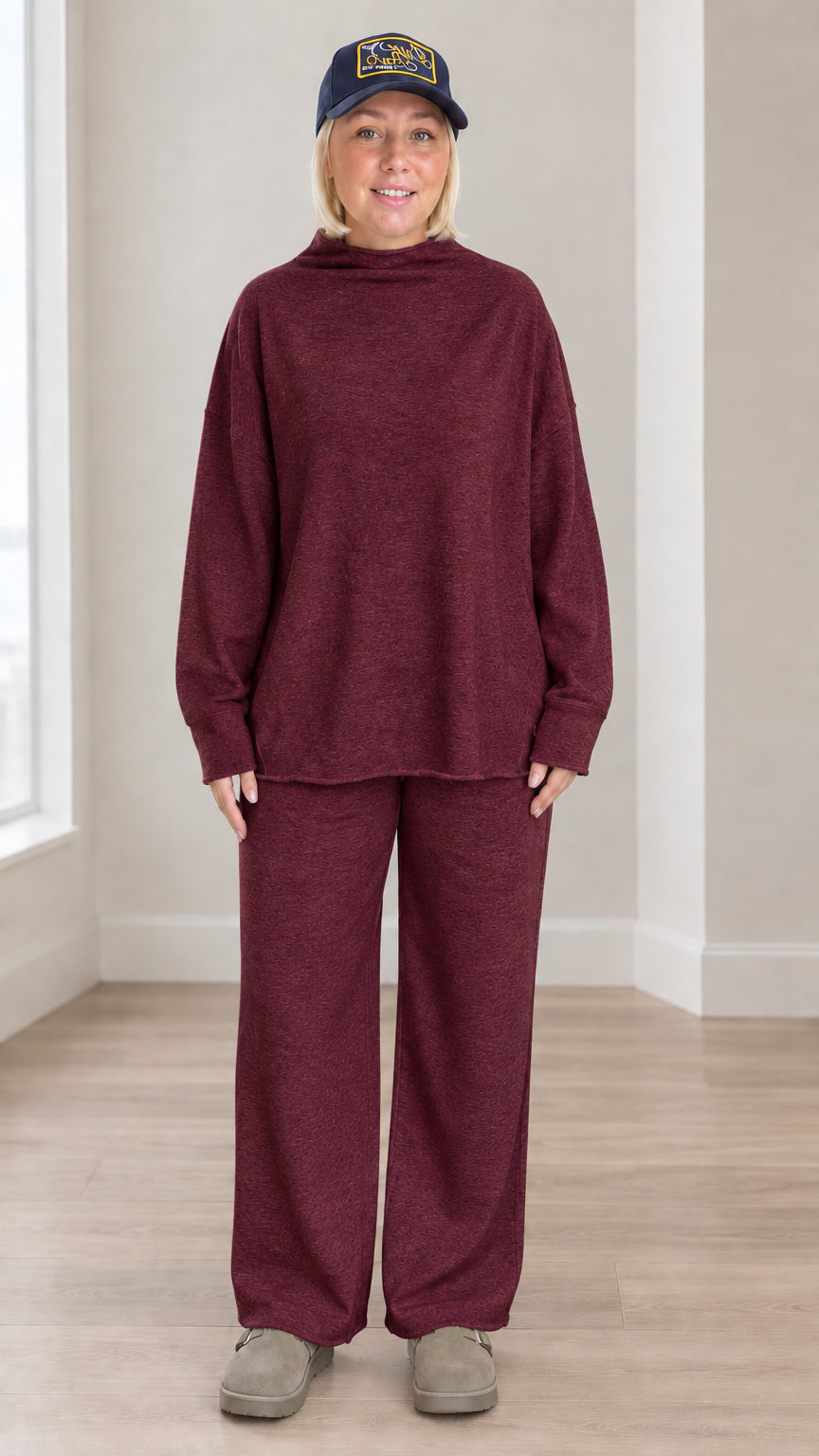 Front view of model wearing burgundy wine mock neck sweatshirt and wide leg lounge set