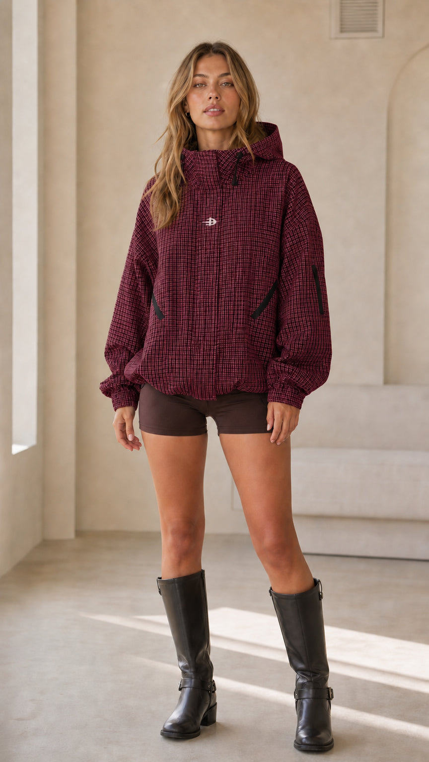 Full front view of woman wearing burgundy houndstooth hooded jacket