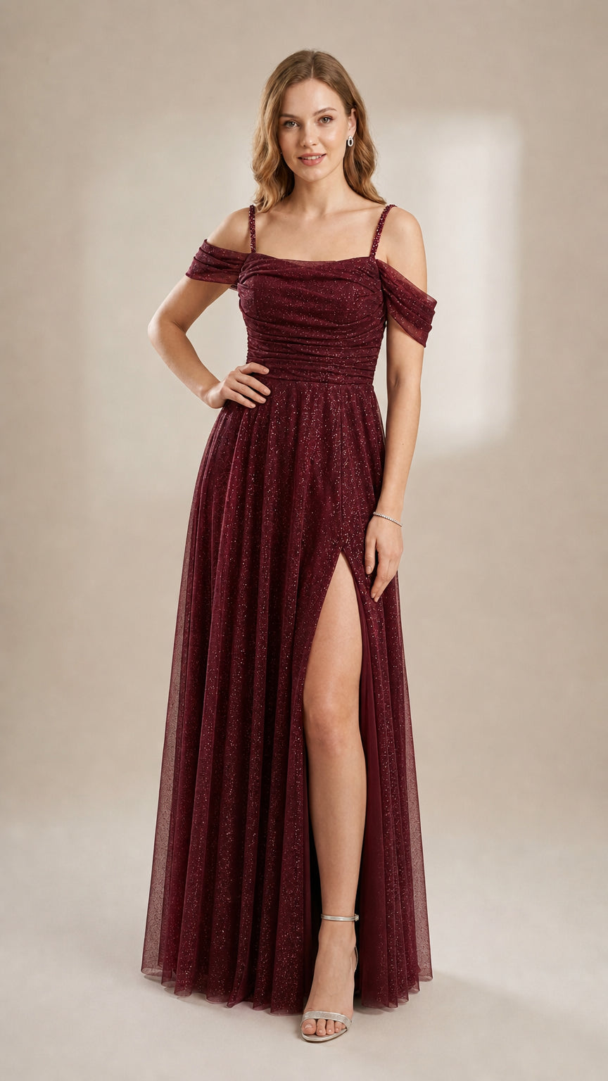 Model in a rich burgundy wine red glitter A-line evening gown with high leg slit