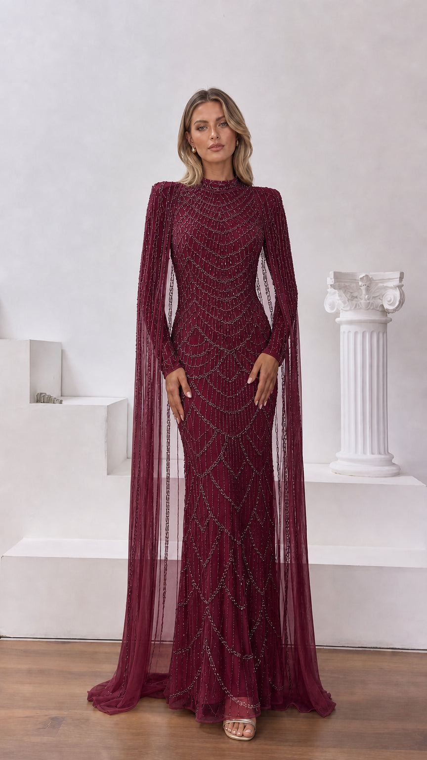 Burgundy wine beaded formal gown featuring elegant floor-sweeping cape drapes