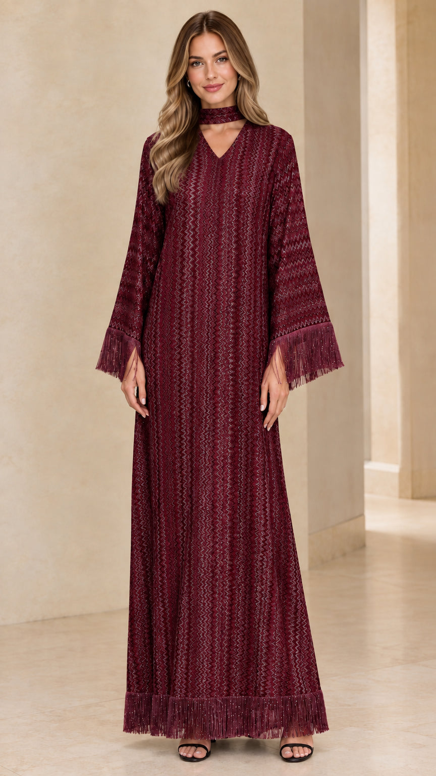 Front view of woman wearing burgundy wine red long sleeve maxi dress with matching choker and fringe hem