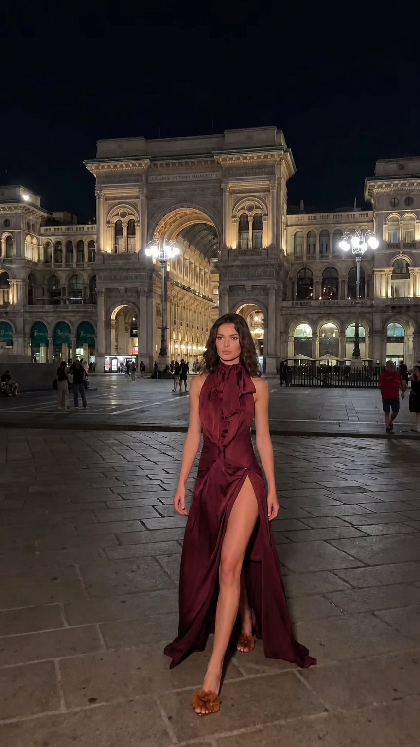 Woman modeling deep burgundy satin halter neck floor-length dress
