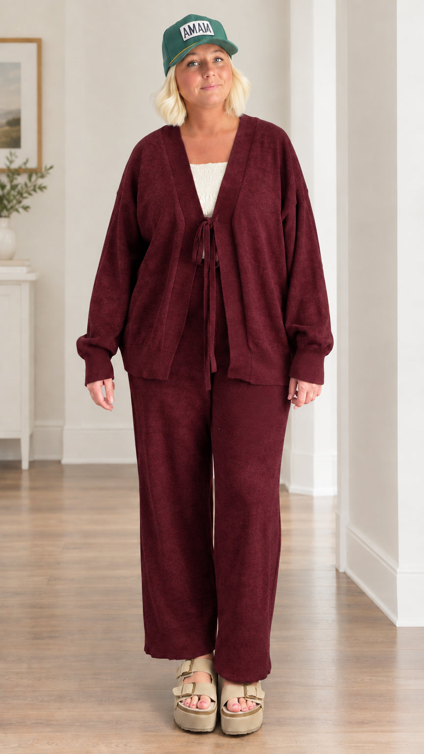 Woman wearing burgundy 2-piece tie-front cardigan and pants matching set