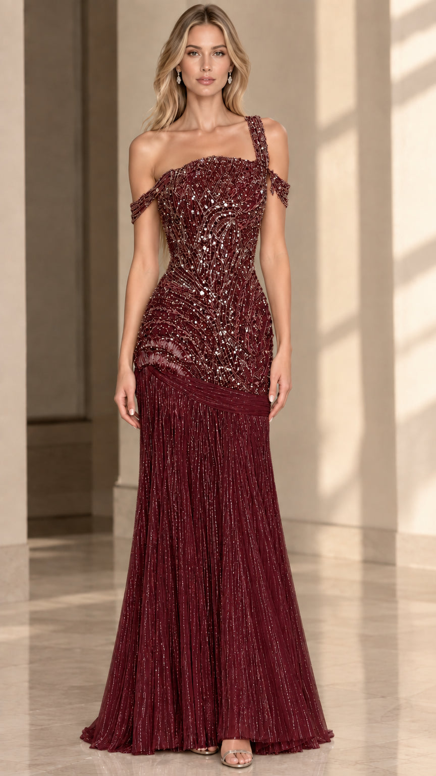 Front view of model wearing Burgundy beaded one-shoulder formal evening dress with pleated skirt