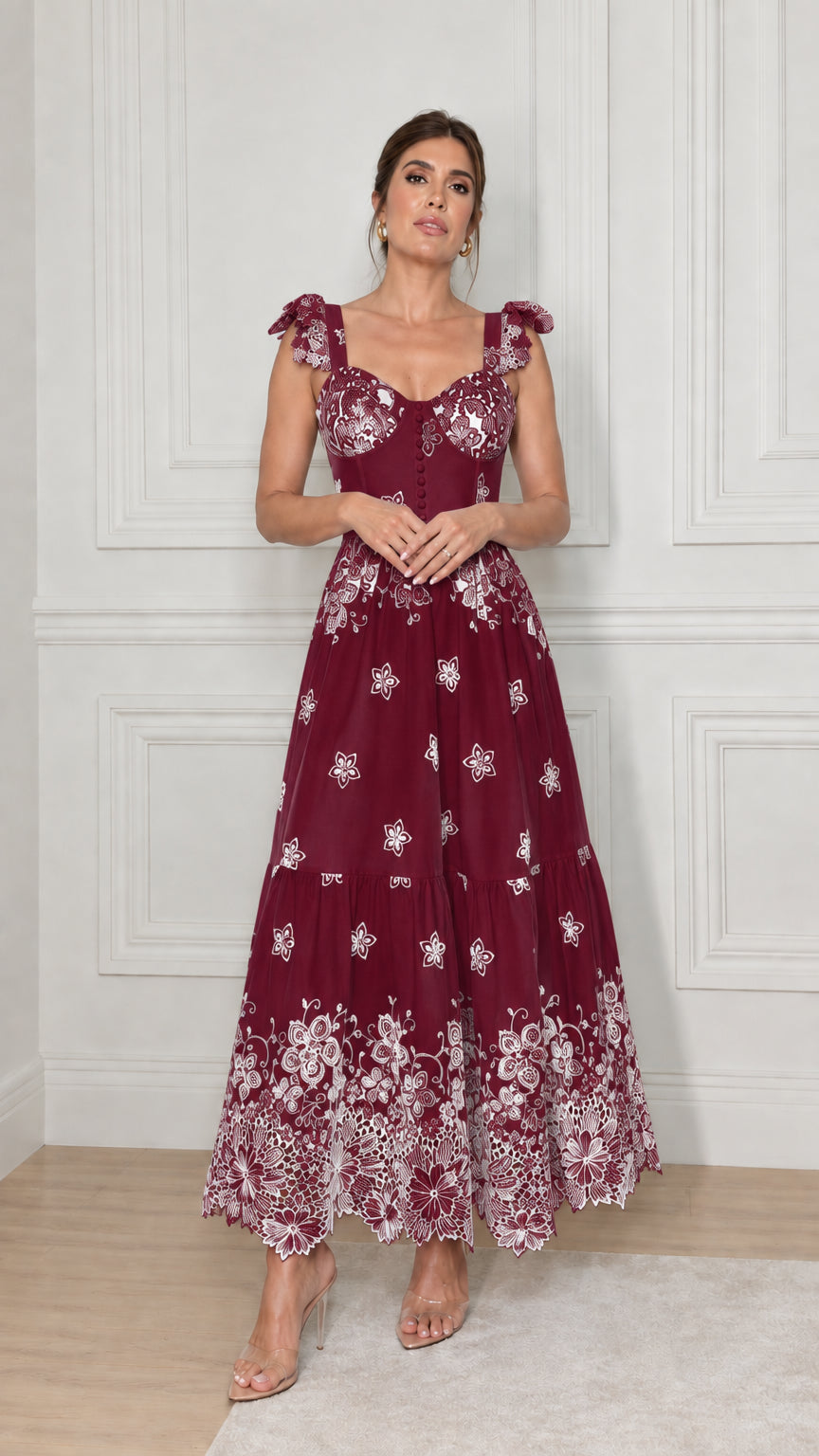 Model wearing rich burgundy tiered maxi dress with floral embroidery and cutwork lace hem
