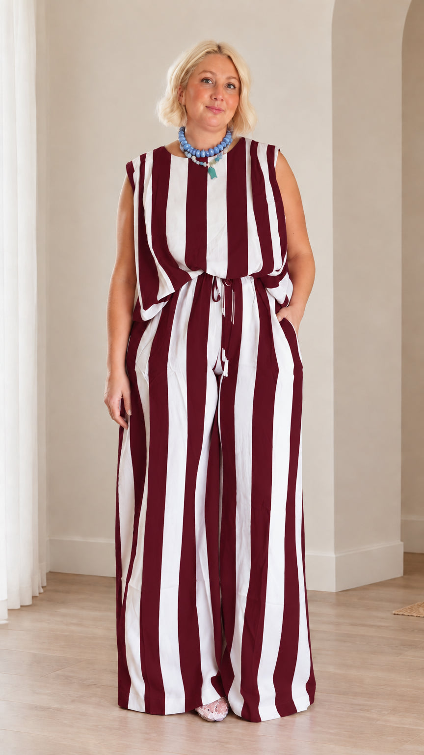 Full front view of woman wearing burgundy and white striped matching top and wide leg pants set