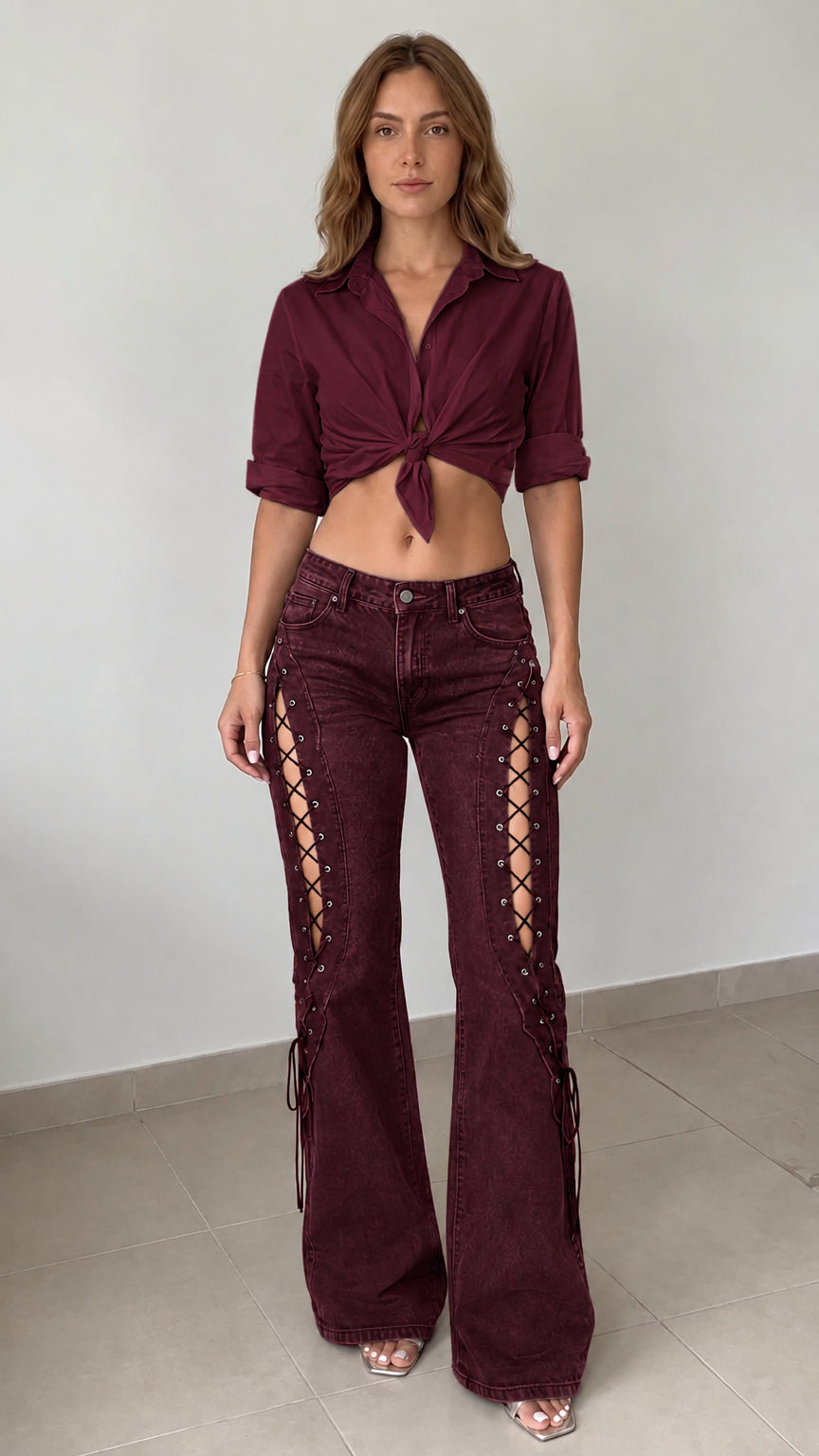Front view of model wearing burgundy wine lace-up cutout flared jeans paired with a matching burgundy shirt