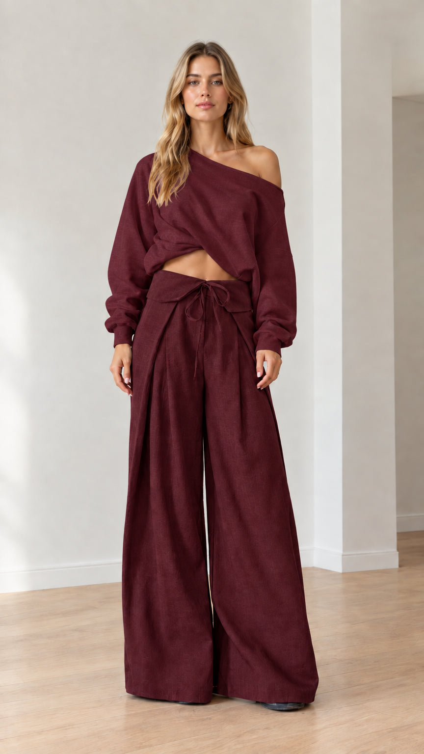 Model wearing matching burgundy off-the-shoulder top and fold-over wide-leg pants set