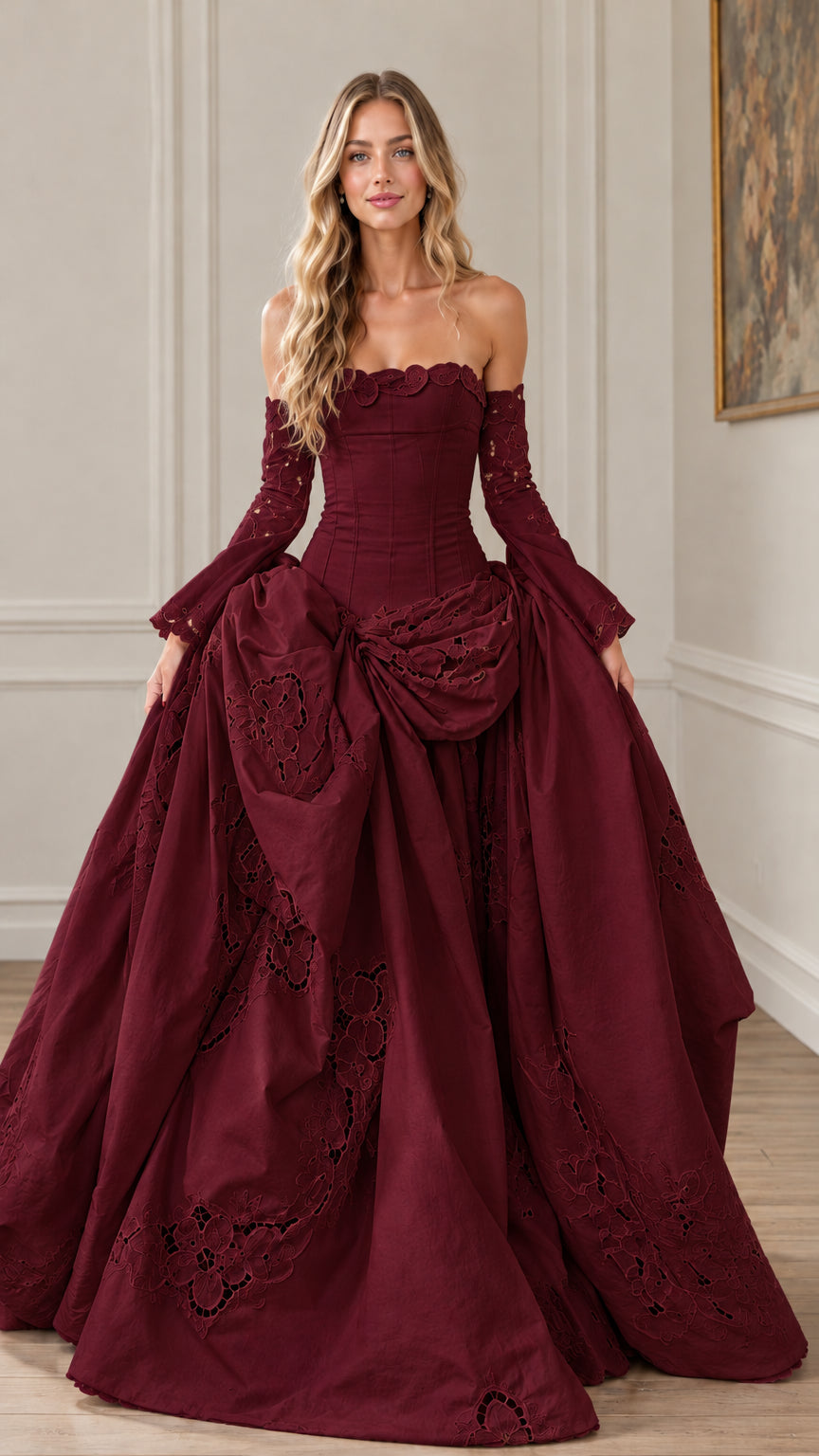 Front view of burgundy red off-the-shoulder corset ball gown with lace-up styling
