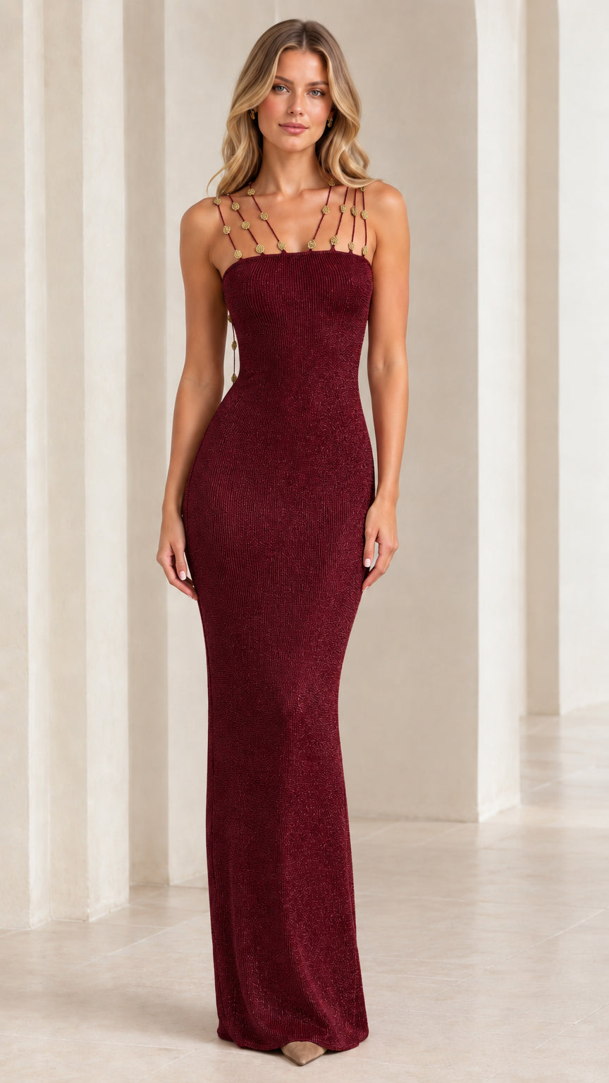 Model wearing burgundy wine metallic knit sleeveless maxi dress with charm-embellished straps